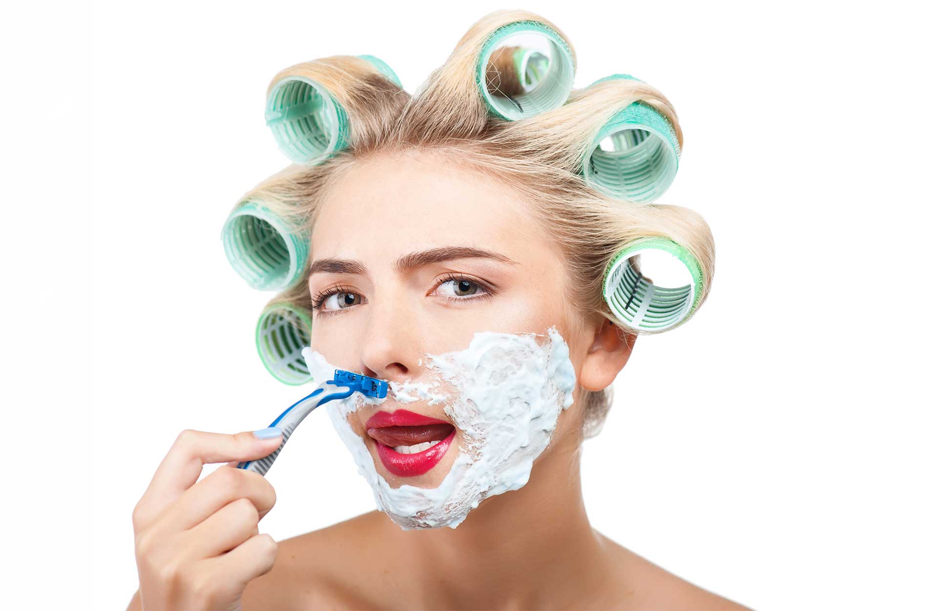 Woman in curlers holding a razor for Austin body waxing at BEAUX MedSpa